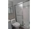 Bathroom with a glass shower enclosure, white tile, and modern toilet and vanity at 1051 S Highland St # 5E, Mount Dora, FL 32757