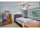 Cozy bedroom with a ceiling fan and natural light, featuring neutral decor at 1051 S Highland St # 5E, Mount Dora, FL 32757