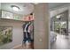 Organized walk-in closet leading to a bedroom with a view of lush greenery at 1051 S Highland St # 5E, Mount Dora, FL 32757