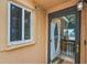 A home's front door with glass, framed by a white doorframe and window with security camera at 1051 S Highland St # 5E, Mount Dora, FL 32757