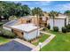 Well-maintained condo complex featuring landscaped walkways, palm trees, and exterior with private balconies at 1051 S Highland St # 5E, Mount Dora, FL 32757