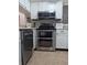 Clean kitchen with stainless steel double oven and white cabinets, with modern countertops at 1051 S Highland St # 5E, Mount Dora, FL 32757