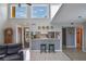 Bright living room with an open kitchen, hardwood floors, and vaulted ceilings at 1051 S Highland St # 5E, Mount Dora, FL 32757