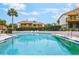 Inviting community pool surrounded by lush landscaping, offering a tranquil escape for residents at 1051 S Highland St # 5E, Mount Dora, FL 32757