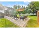 Outdoor patio with a seating area, pool, and umbrella for shade, creating a relaxing backyard oasis at 1141 Waldorf Ct, Winter Springs, FL 32708