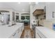 Bright kitchen with a large island, white cabinets, stainless appliances, and wood look floors at 1141 Waldorf Ct, Winter Springs, FL 32708