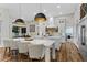 A gourmet kitchen with white cabinets, an oversized island, and stainless steel appliances at 1141 Waldorf Ct, Winter Springs, FL 32708
