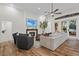 Spacious living area with fireplace and hardwood floors, seamlessly connects to the kitchen at 1141 Waldorf Ct, Winter Springs, FL 32708