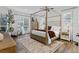 Sun-filled main bedroom featuring a four-poster bed and neutral decor at 1141 Waldorf Ct, Winter Springs, FL 32708