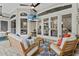Cozy outdoor patio featuring comfortable seating, a ceiling fan, and views of the lush surroundings at 1141 Waldorf Ct, Winter Springs, FL 32708