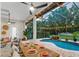 Outdoor dining area with a stunning pool and waterfall feature, perfect for entertaining at 1141 Waldorf Ct, Winter Springs, FL 32708