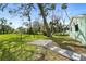 Expansive backyard featuring a walkway, mature trees and partial fencing at 124 Oak Ridge Ave, Edgewater, FL 32132