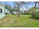 Spacious fenced backyard with large shade tree and ample green space at 124 Oak Ridge Ave, Edgewater, FL 32132