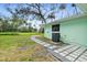 Serene backyard featuring pavers, lush lawn, and tropical accents for outdoor living at 124 Oak Ridge Ave, Edgewater, FL 32132