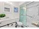 Updated bathroom with a glass-enclosed shower featuring marble-style tile and modern fixtures at 124 Oak Ridge Ave, Edgewater, FL 32132