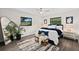 Comfortable bedroom with stylish decor, including a large mirror, ceiling fan, and hardwood flooring at 124 Oak Ridge Ave, Edgewater, FL 32132