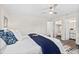 Bright bedroom featuring a ceiling fan, ensuite bathroom, and walk-in closet for ample storage space at 124 Oak Ridge Ave, Edgewater, FL 32132