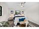 Bright bedroom with natural light, a ceiling fan, stylish decor, and hardwood floors at 124 Oak Ridge Ave, Edgewater, FL 32132