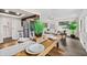 Bright dining area with wood table, open to living room and kitchen with stainless steel refrigerator at 124 Oak Ridge Ave, Edgewater, FL 32132