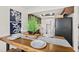 Dining area with wood table, decor, with view to kitchen featuring stainless steel refrigerator at 124 Oak Ridge Ave, Edgewater, FL 32132