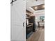 Modern kitchen with stainless appliances, granite countertops, dark wood cabinets, and a stylish barn door at 124 Oak Ridge Ave, Edgewater, FL 32132