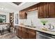 Stylish kitchen with granite countertops, dark wood cabinets, and breakfast bar at 124 Oak Ridge Ave, Edgewater, FL 32132