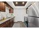 Modern kitchen featuring stainless steel appliances, granite countertops, and dark wood cabinets at 124 Oak Ridge Ave, Edgewater, FL 32132