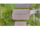 Aerial view of the house shows roof, surrounding yard and neighborhood, with mature trees at 13826 Mirror Lake Dr, Orlando, FL 32828