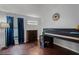 Bedroom with hardwood floors, a loft bed, dresser, and a window with blue curtains at 13826 Mirror Lake Dr, Orlando, FL 32828