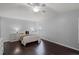 Bedroom featuring hardwood floors, neutral walls, a ceiling fan, and a comfortable bed with stylish bedding at 13826 Mirror Lake Dr, Orlando, FL 32828