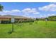 Outdoor adult exercise equipment available for residents in a well-maintained, grassy common area under a bright, partly cloudy sky at 13826 Mirror Lake Dr, Orlando, FL 32828