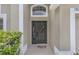 Inviting front entrance with decorative wreath and beautiful landscaping at 13826 Mirror Lake Dr, Orlando, FL 32828