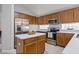 Spacious kitchen featuring wood cabinets, stainless steel appliances, and a central island at 13826 Mirror Lake Dr, Orlando, FL 32828