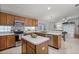 Well-lit kitchen featuring wood cabinets, stainless steel appliances, and a central island at 13826 Mirror Lake Dr, Orlando, FL 32828