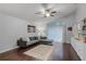 Comfortable living room with a modern sectional, ceiling fan, and access to the patio at 13826 Mirror Lake Dr, Orlando, FL 32828