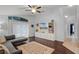 Cozy living area with hardwood floors, ceiling fan, built-in shelving, and access to the patio at 13826 Mirror Lake Dr, Orlando, FL 32828