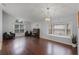 Spacious living room with hardwood floors, an elegant light fixture, and large windows at 13826 Mirror Lake Dr, Orlando, FL 32828