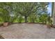 Stamped concrete patio with lovely green space and potted plants creates a calm outdoor oasis at 13826 Mirror Lake Dr, Orlando, FL 32828