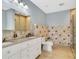 A renovated bathroom with a double vanity, decorative tile, and a walk-in shower at 151 E Washington St # 5B, Orlando, FL 32801