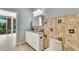 Bathroom featuring a double sink vanity, decorative tile and natural light at 151 E Washington St # 5B, Orlando, FL 32801