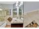 Bathroom features a vanity, sink, mirror, lighting fixtures and mosaic tiled walls at 151 E Washington St # 5B, Orlando, FL 32801