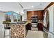 Bright kitchen features modern appliances, mosaic tile accents, and stunning city views from the breakfast bar at 151 E Washington St # 5B, Orlando, FL 32801