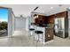 Modern kitchen with a breakfast bar, stainless steel refrigerator, and contemporary lighting at 151 E Washington St # 5B, Orlando, FL 32801