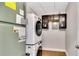 Functional laundry room with stacked washer and dryer and cabinet storage at 151 E Washington St # 5B, Orlando, FL 32801