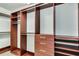 Spacious walk-in closet with custom wood shelving, hanging rods, and ample storage space at 151 E Washington St # 5B, Orlando, FL 32801