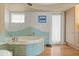 Bathroom with a unique blue wave tile feature and a large bathtub at 151 N Orlando Ave # 212, Winter Park, FL 32789