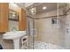 Updated bathroom with a glass enclosed shower, pedestal sink, and modern fixtures at 151 N Orlando Ave # 212, Winter Park, FL 32789