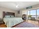 Bright bedroom with a large window, hardwood floors, ceiling fan, and stylish decor at 151 N Orlando Ave # 212, Winter Park, FL 32789