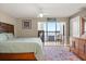 Bedroom with a large window, hardwood floors, and a stylish headboard at 151 N Orlando Ave # 212, Winter Park, FL 32789