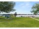 Community outdoor space with picnic tables, lounge chairs, lake views, and pool area at 151 N Orlando Ave # 212, Winter Park, FL 32789